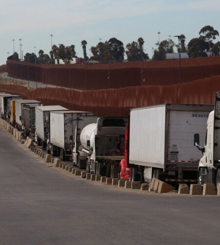 Trailer trucks queue to cross into the United States at the Otay Mesa Port of Entry, in Tijuana, Mexico, November 27, 2024.