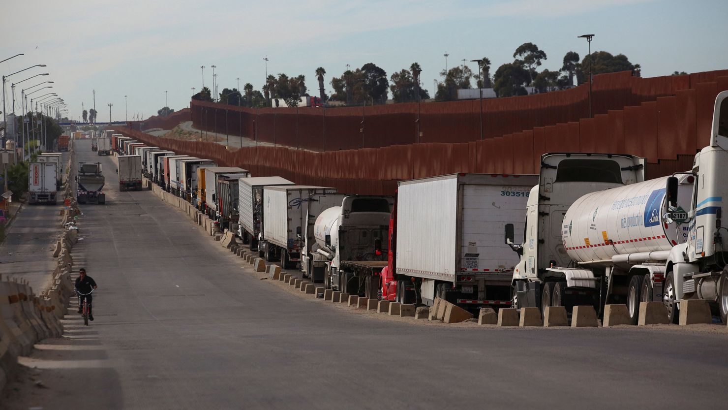 Trailer trucks queue to cross into the United States at the Otay Mesa Port of Entry, in Tijuana, Mexico, November 27, 2024.